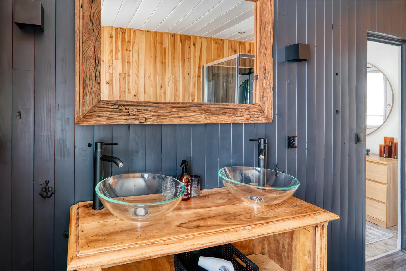 Salle de bain avec double vasque en verre et meuble en bois